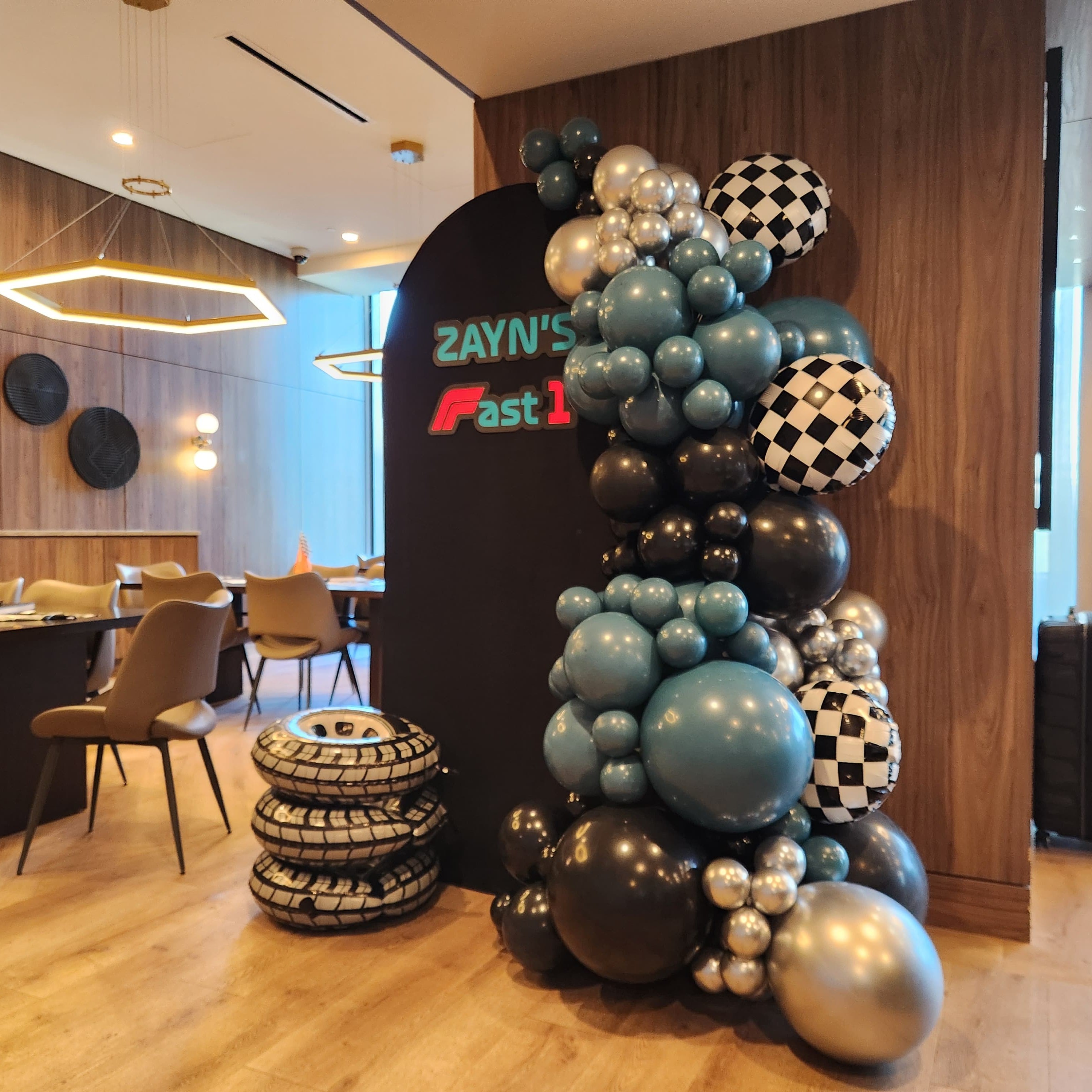 Racing themed balloon column installation
